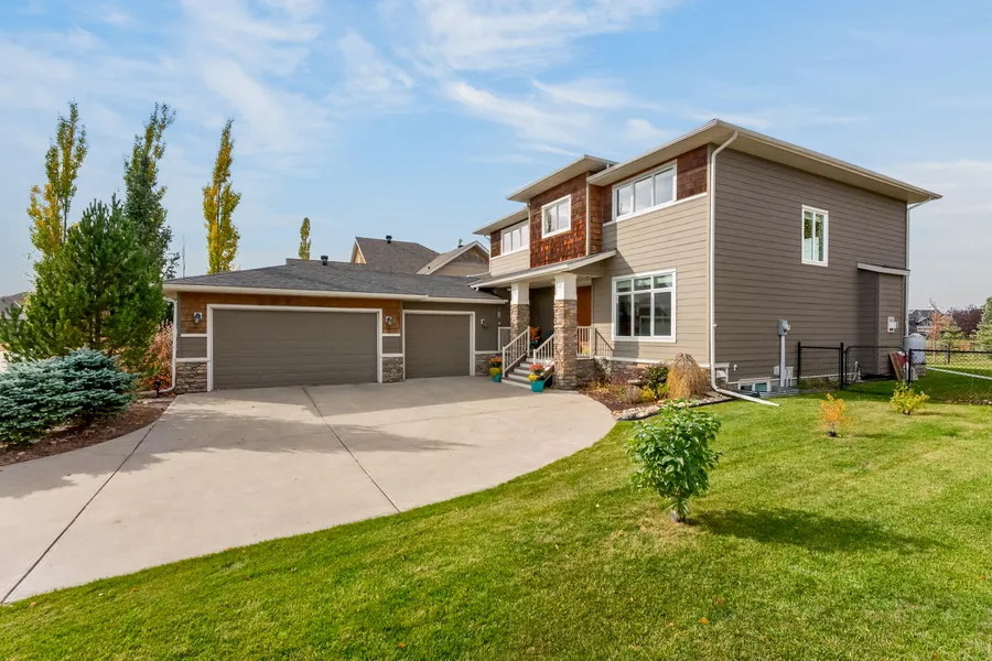 Front elevation, triple garage and curved drive