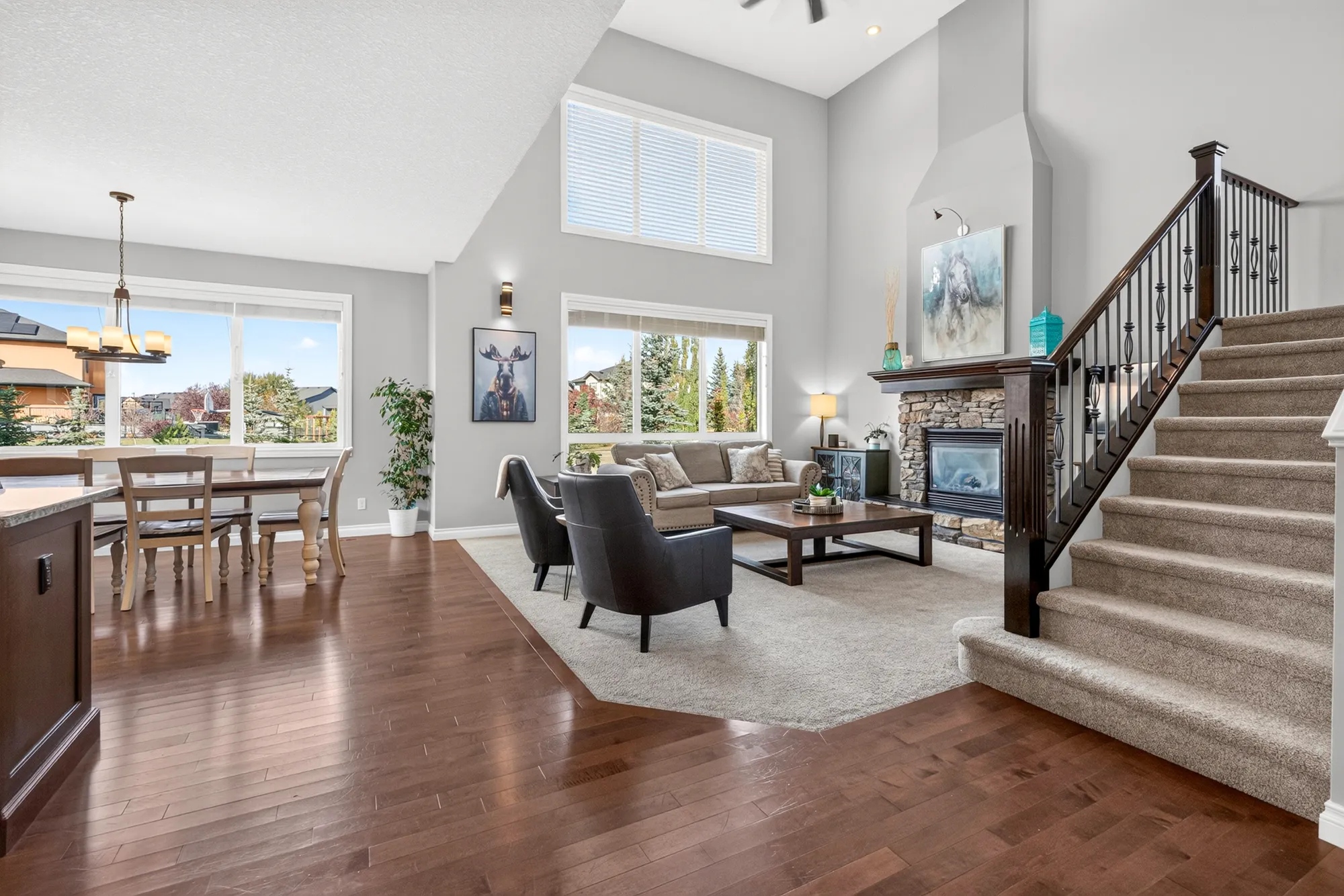 The great room at 34 Monterra Link, with a vaulted ceiling and a stone-surround gas fireplace.