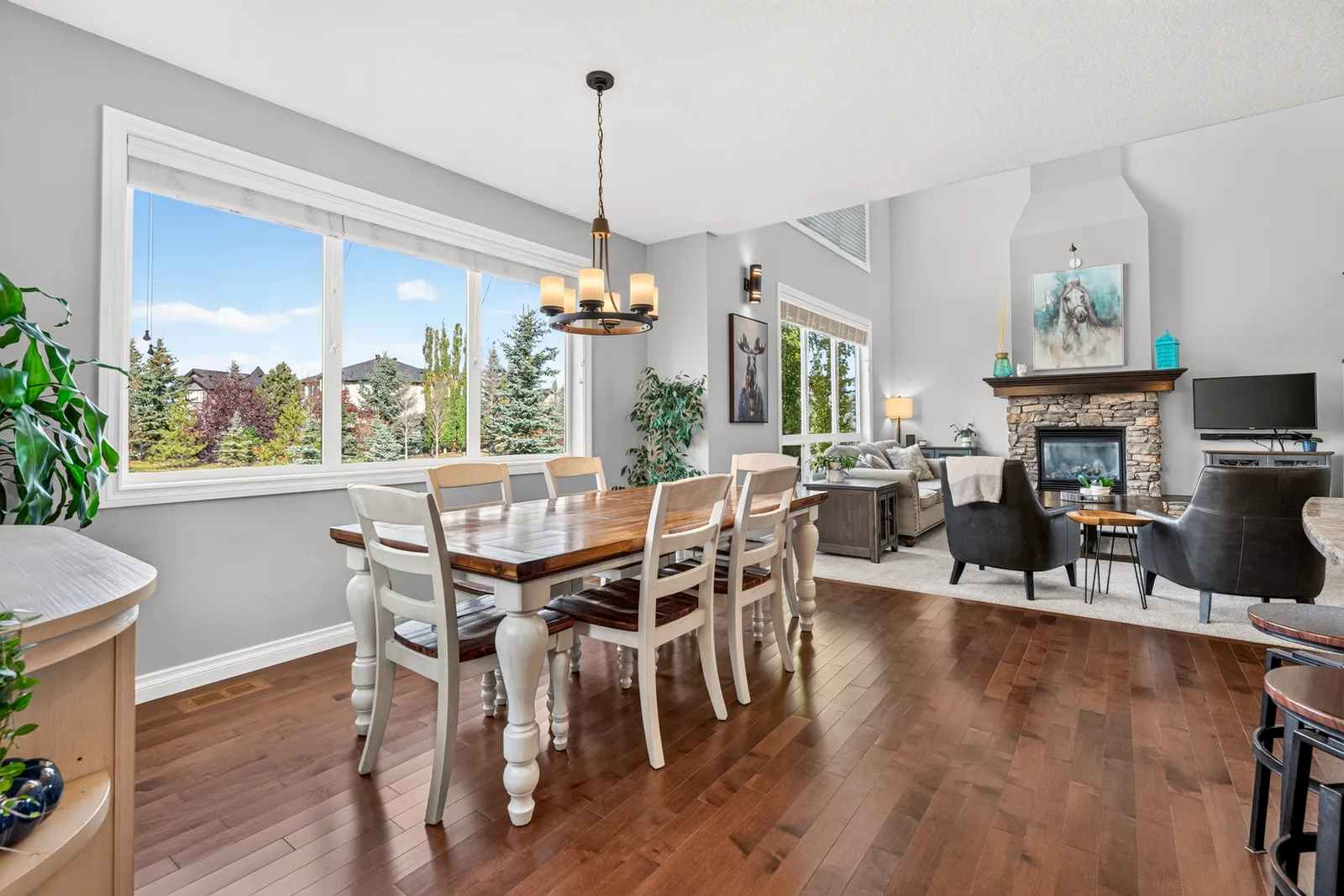 The dining room at 34 Monterra Link, open to the kitchen with windows onto the yard.